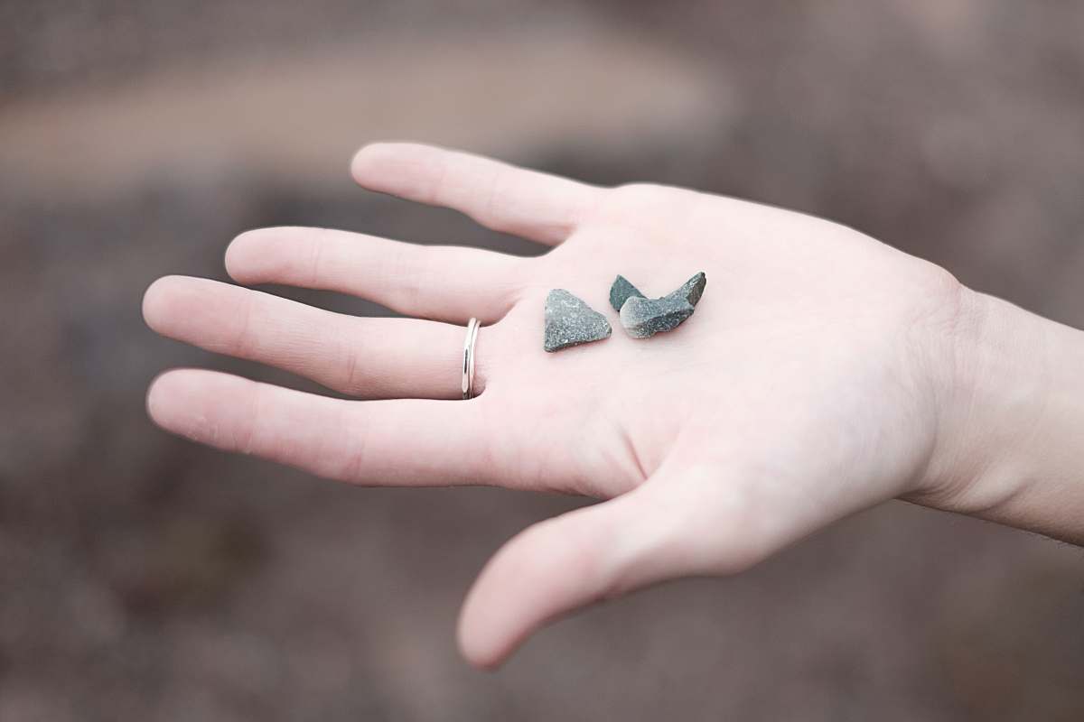 person three gray pebbles on person's palm human