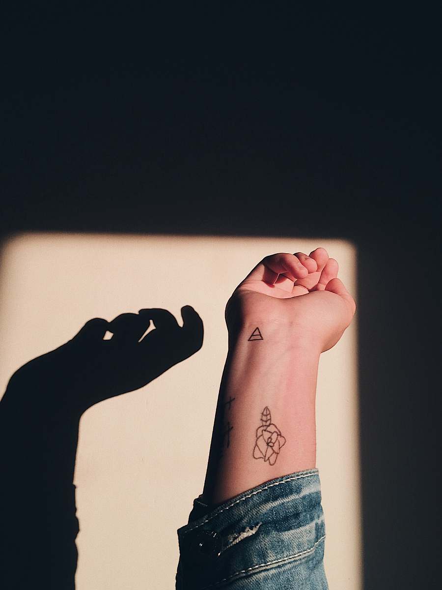 skin woman having rose tattoo wrist