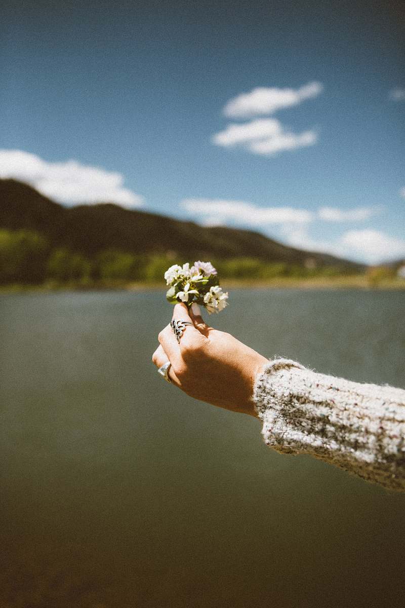 flower woman holding white petaled flowers flowers