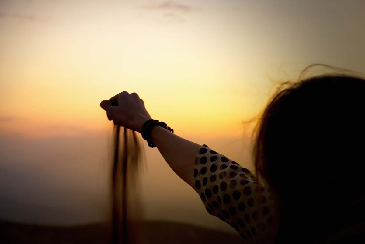 person woman holds sand holding hands