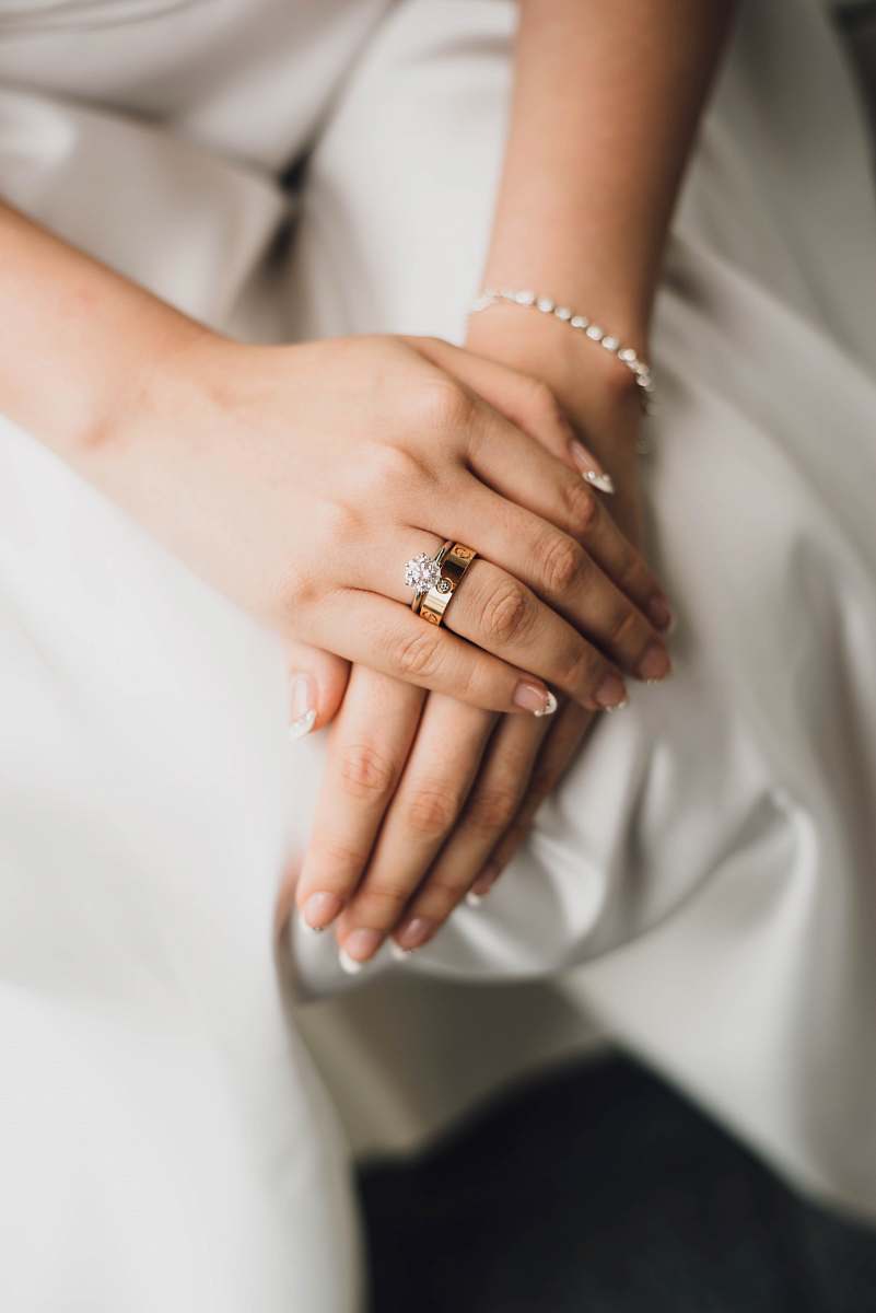 wedding woman wearing gold-colored and silver-colored rings ring