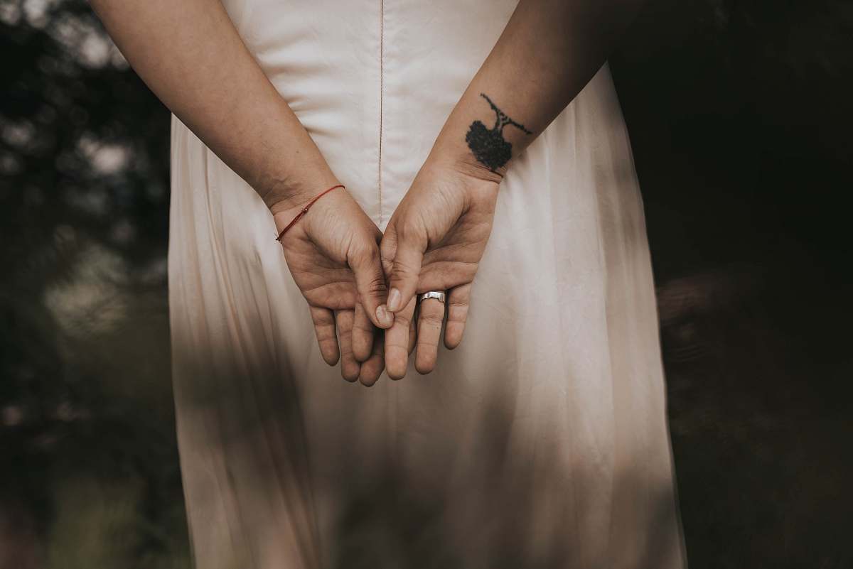 human woman wearing silver-colored ring holding hands