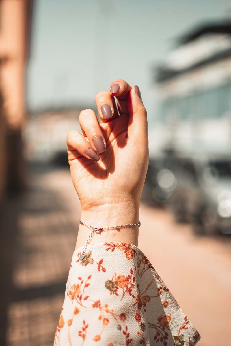 finger women's white and orange floral shirt person