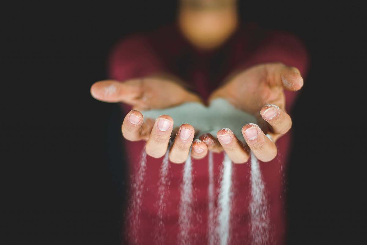 hand person holding blue sand holding