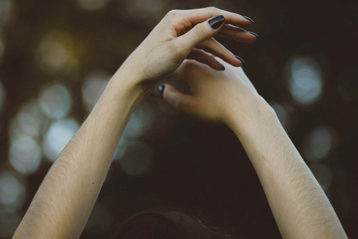 hand person with black nail polish arms