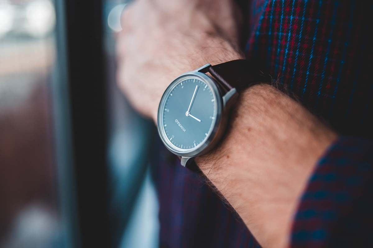 person black analog watch reading 9:03 wristwatch