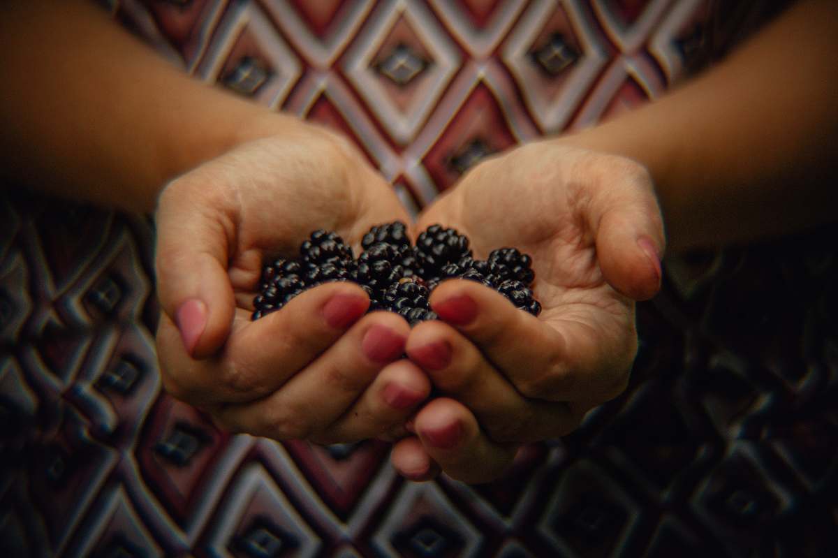 person black berries finger