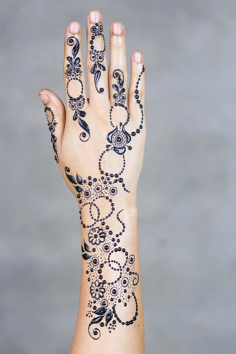 person black mehndi tattoo hand