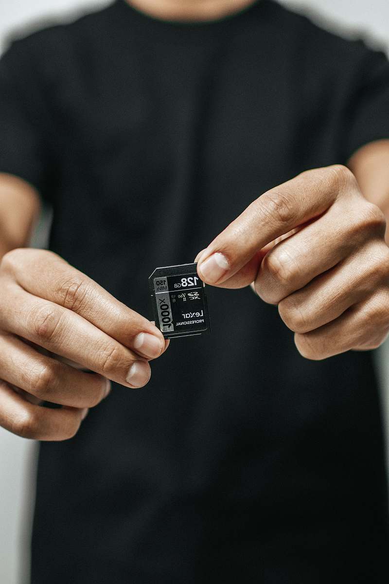 person black micro SD card adapter hand