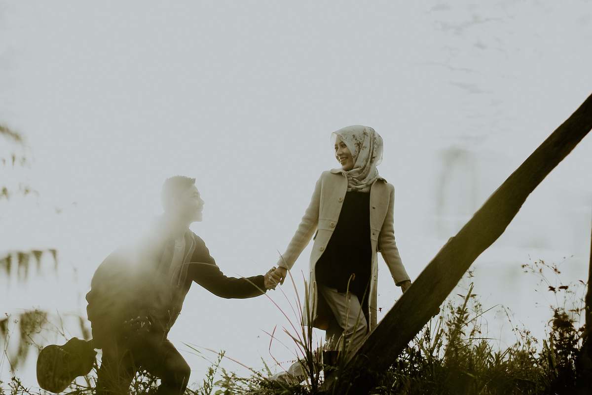 person couple holding hands during daytime hand