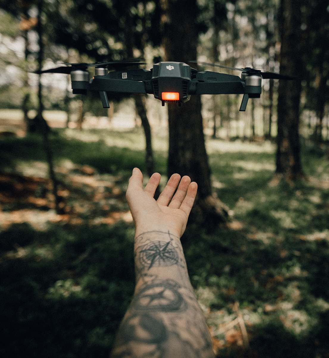 skin drone flying above hand tattoo