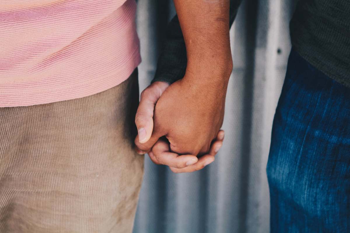 person focus photo of couple's hands people