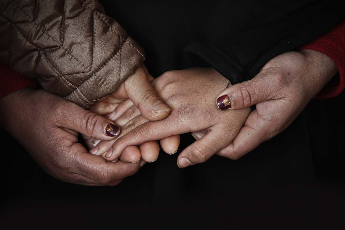 person four hands holding people