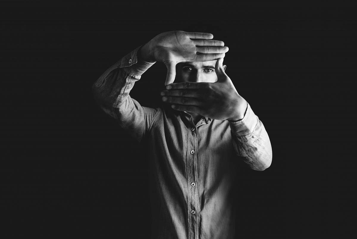 person grayscale photography of man wearing dress shirt black-and-white