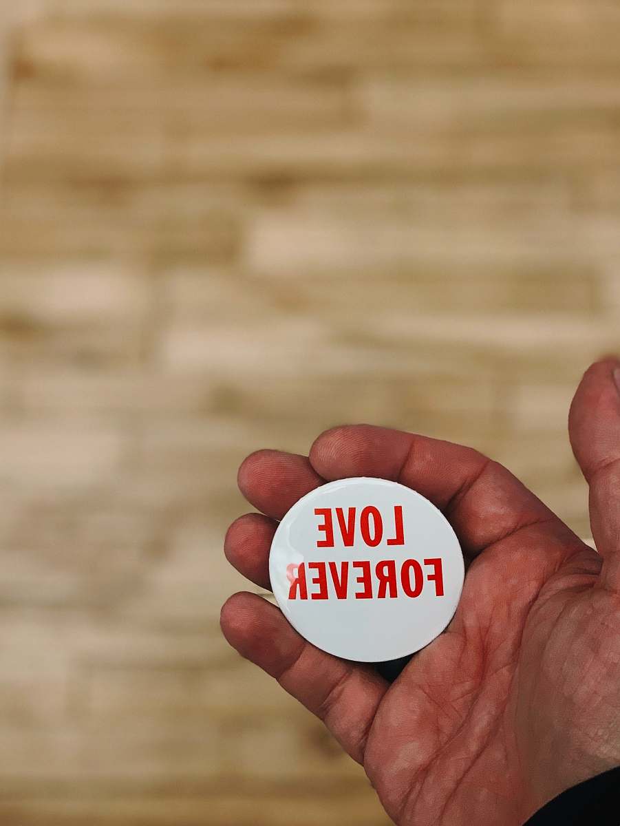 person love forever button finger