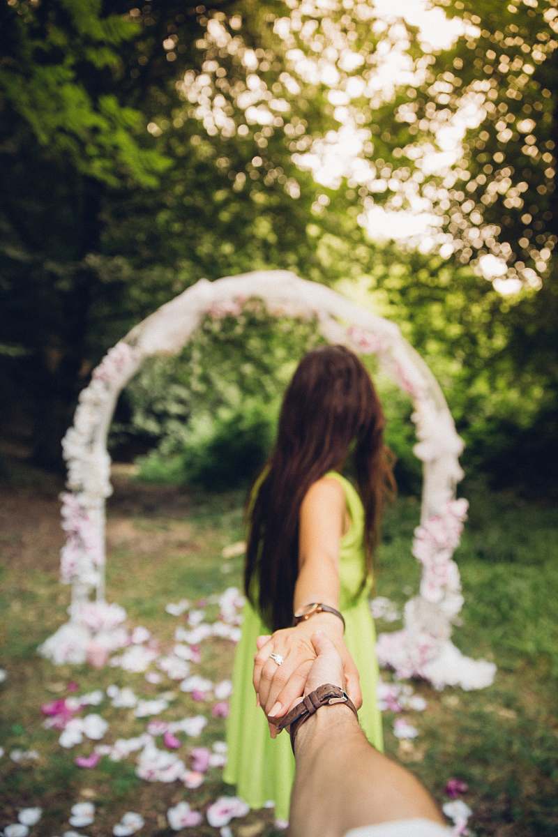 woman man and woman holding hands near flower female
