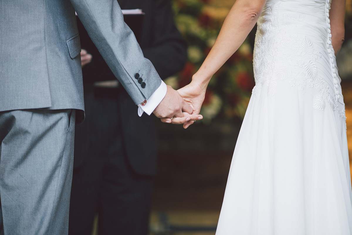 hand man holding a woman's hands in front of a person holding hands