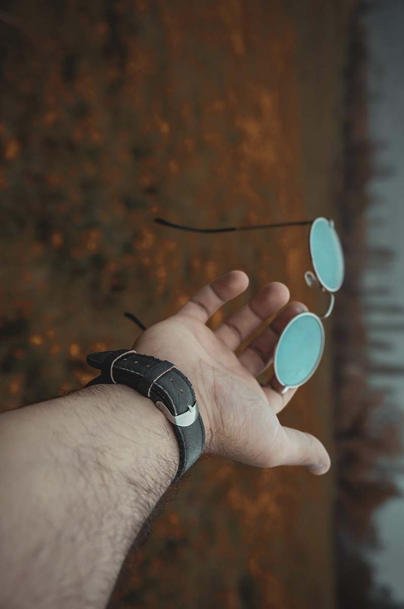 hand man holding hippie sunglasses wristwatch