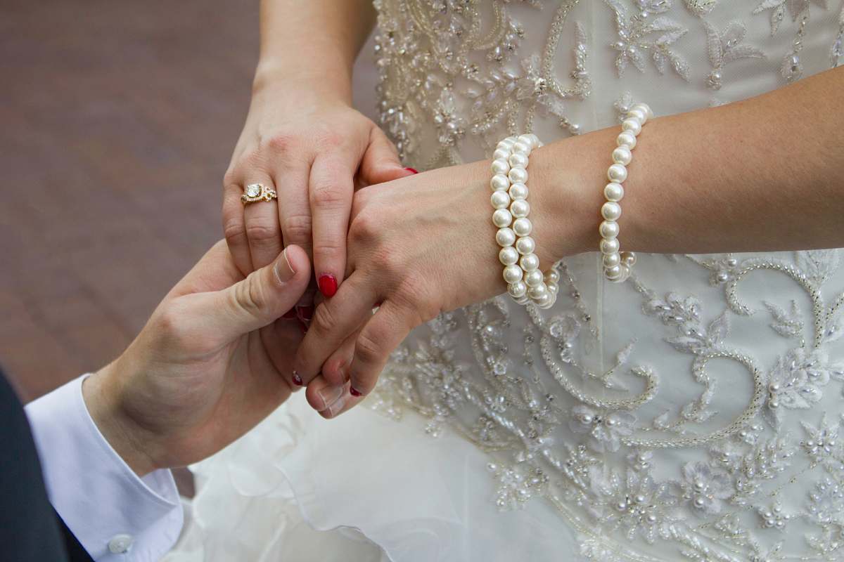 person man holding woman's hand finger