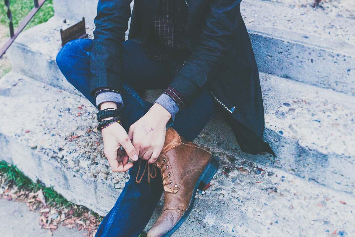 person man sitting on concrete stair hands