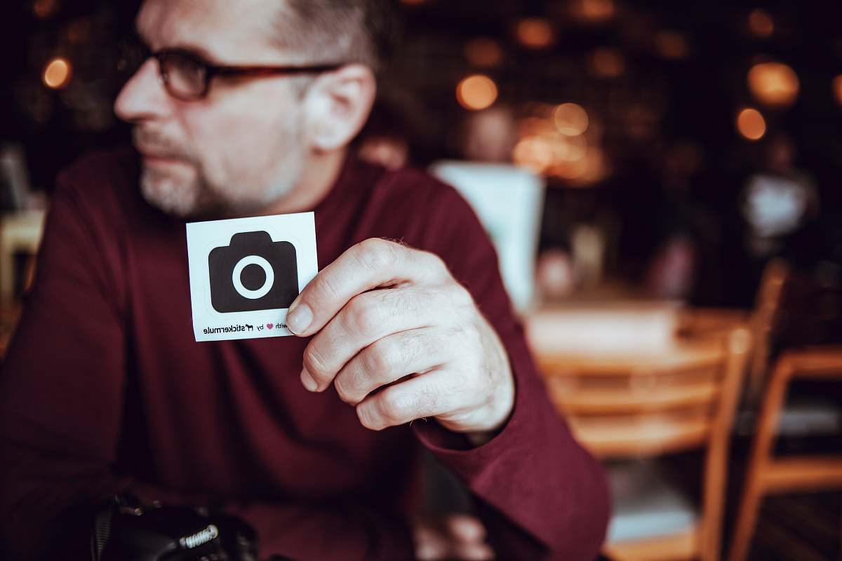 person man walking a card with camera icon sticker