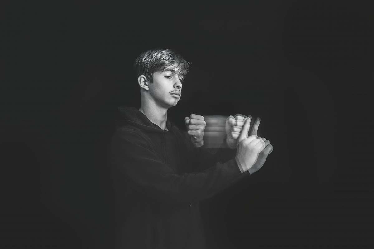 person man wearing black pullover hoodie black-and-white