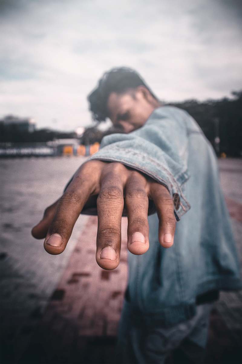 person man wearing blue chambray jacket hand