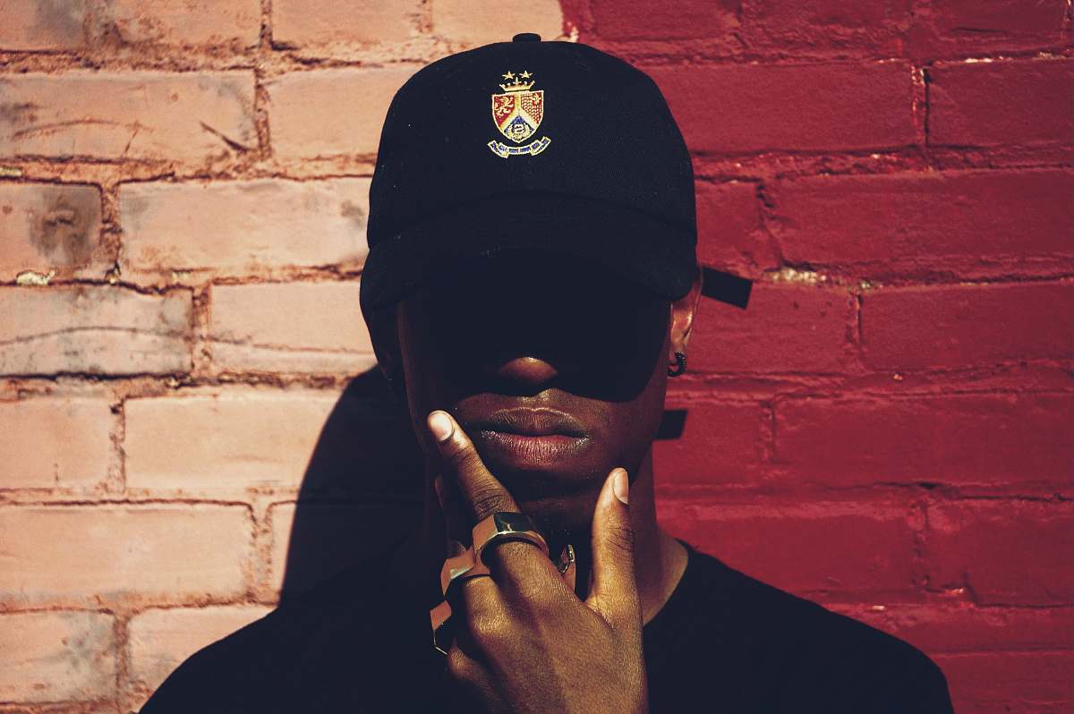 person man with cap and background with red and pink wall l people
