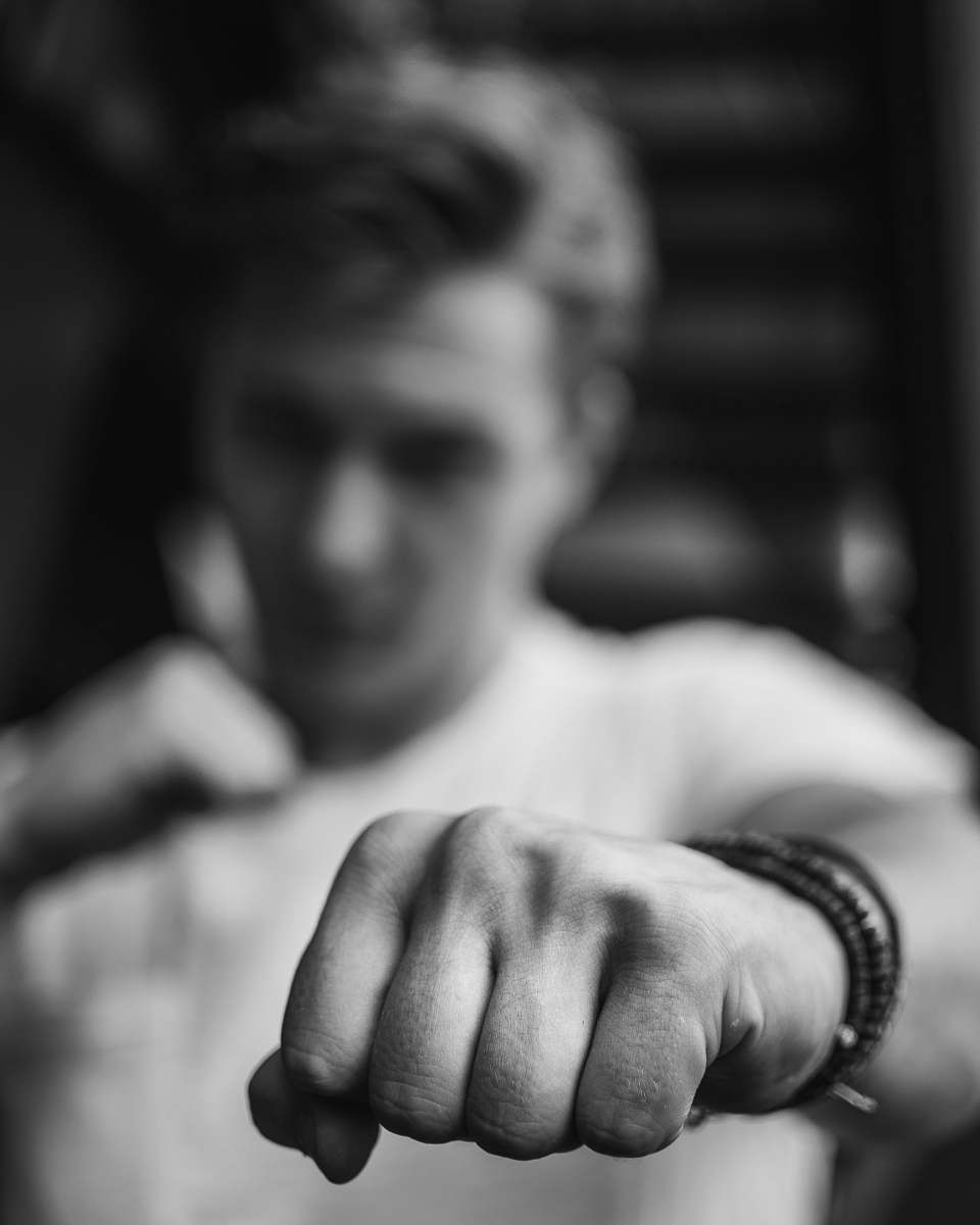 person man with his arms clench black-and-white