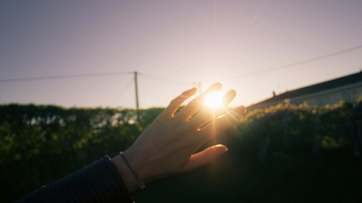 flare men's right hand during daytime light