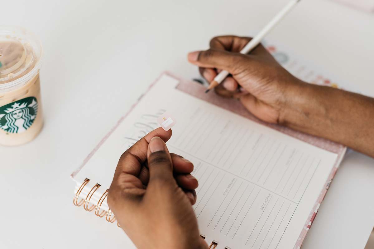 person person about to write on notebook text