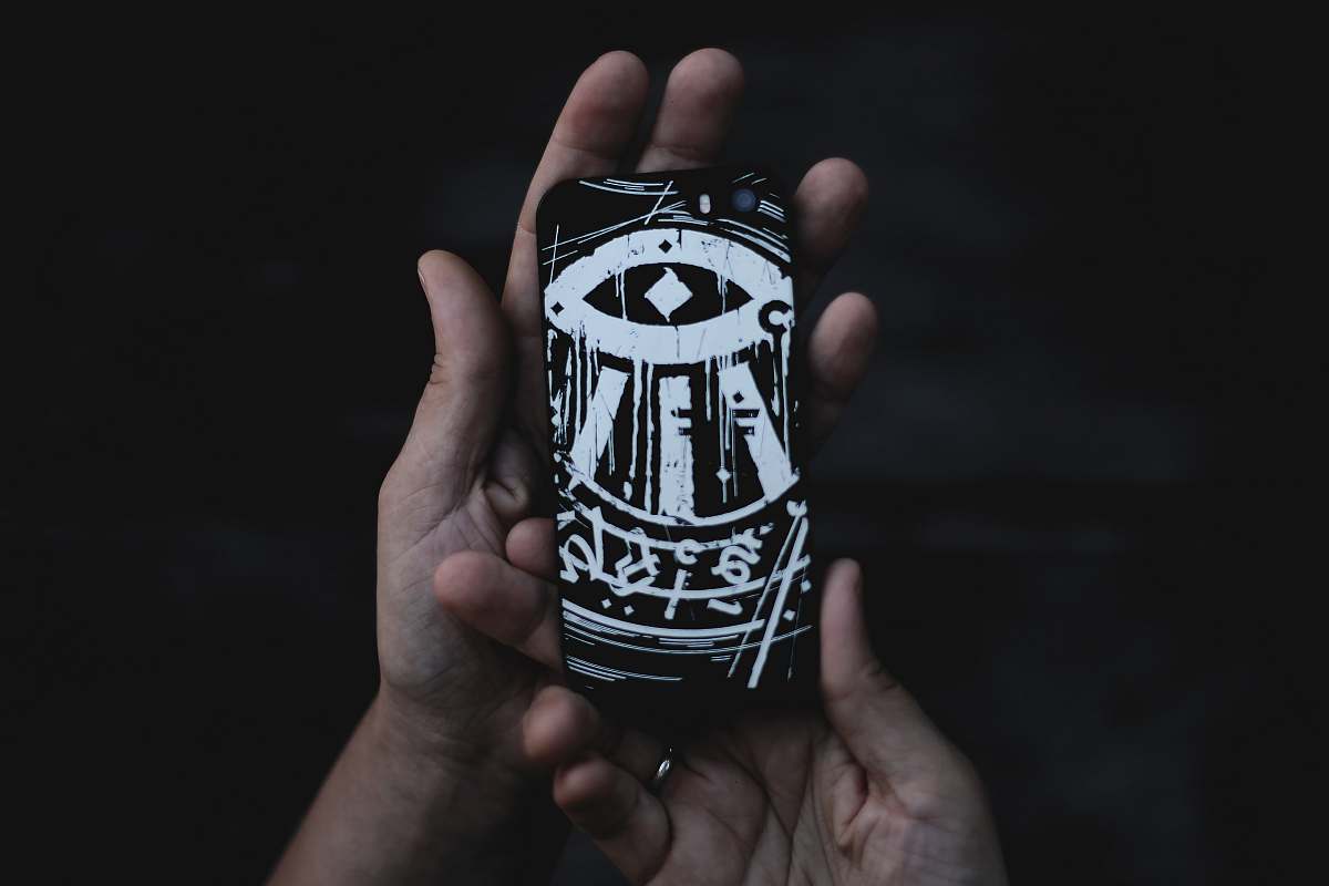 person person holding black and white phone case people