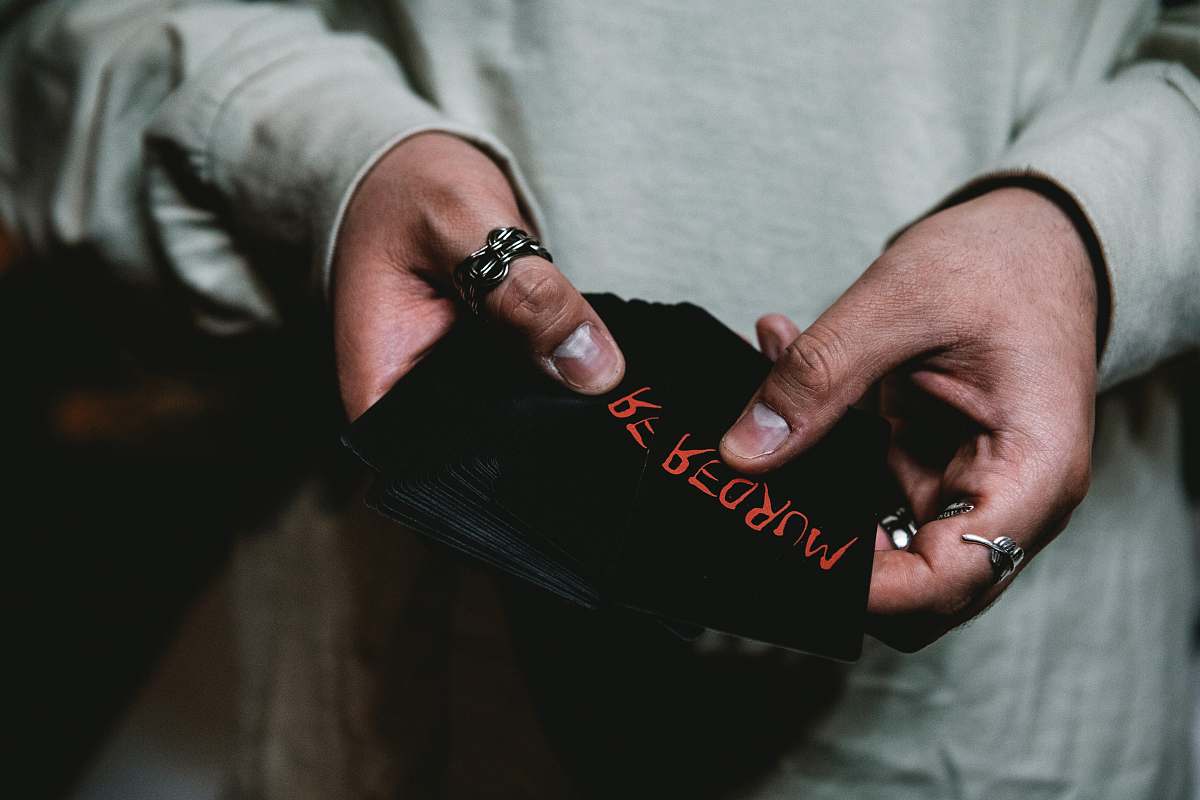 person person holding black cap finger