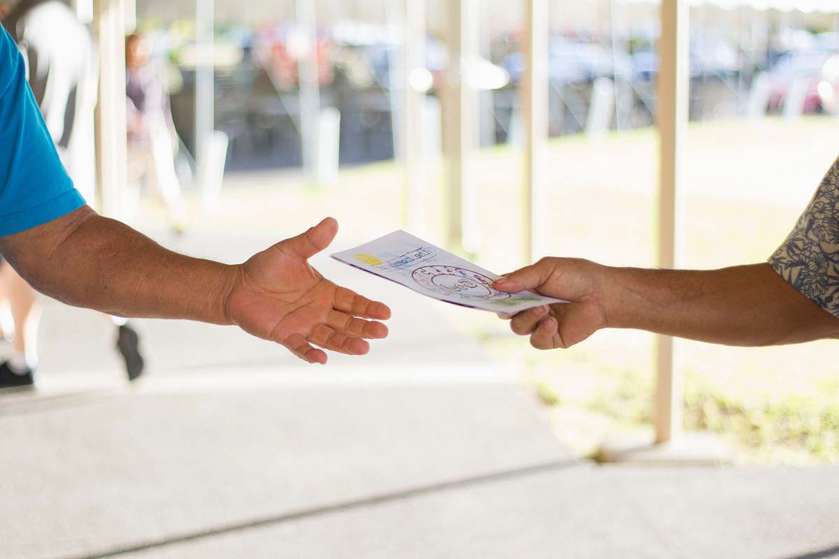 person person holding card advertisement