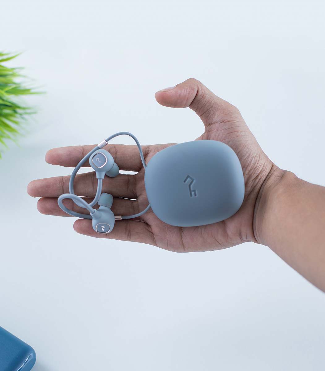 person person holding earbuds and case sunglasses