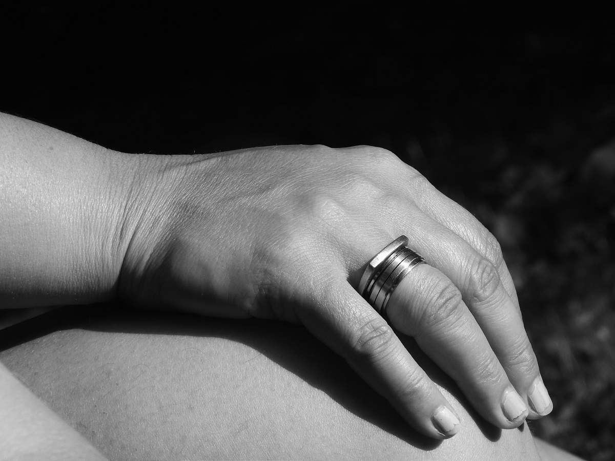 black-and-white person in silver ring grey