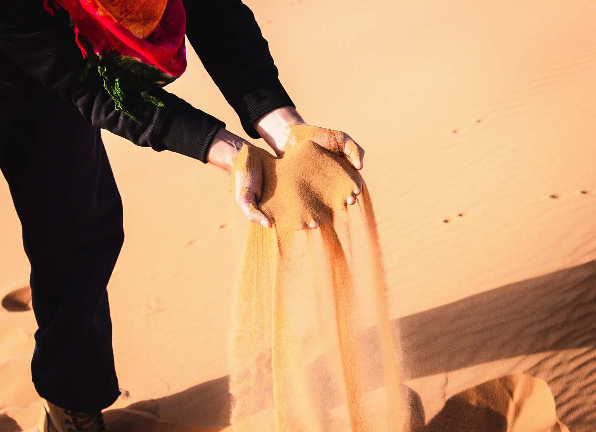 hand person pouring sand holding hands