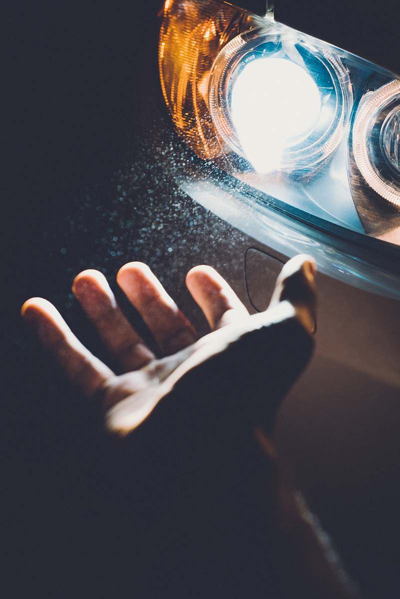 person person showing car headlight hand