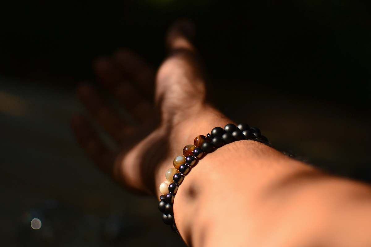 person person wearing beaded bracelet hand