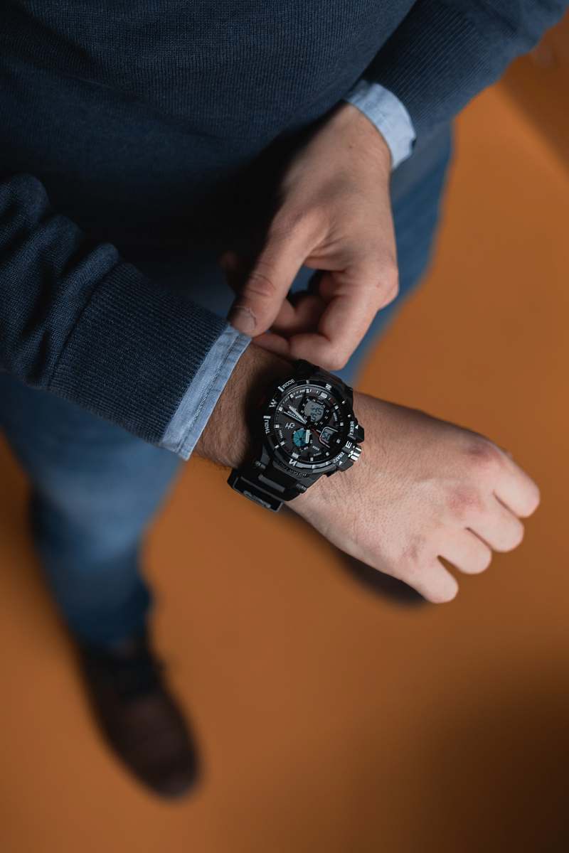 person person wearing round black analog digital watch wristwatch