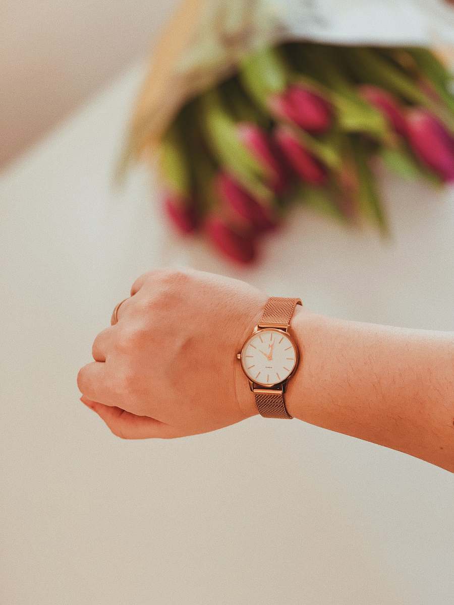 person person wearing round gold-colored framed analog watch hand
