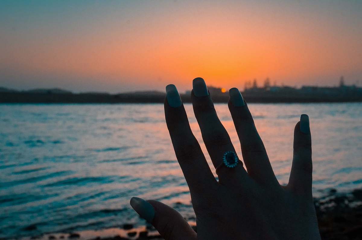 person person wearing silver-colored ring finger