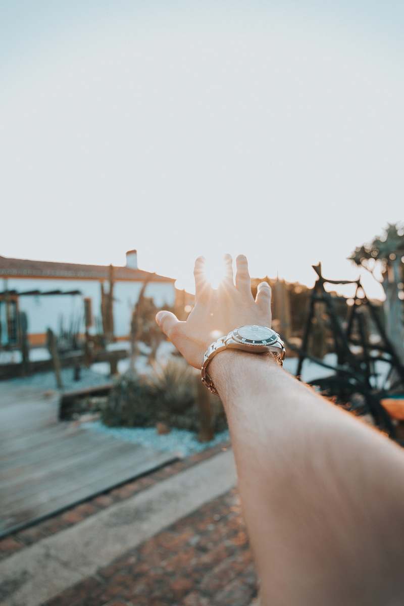 person person with round white analog watch hand