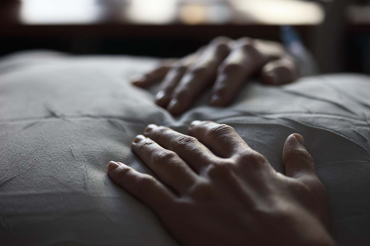 person person's hand on white textile grey