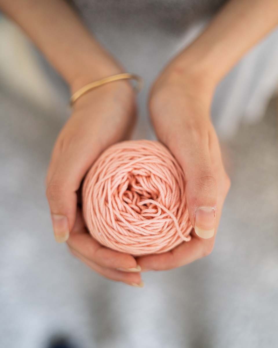 person pink thread wool