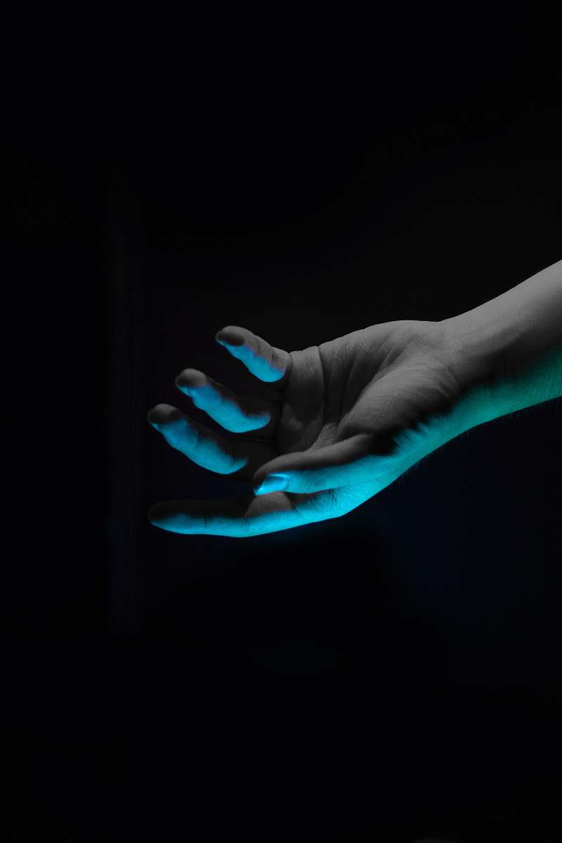 person right human hand above blue light hand