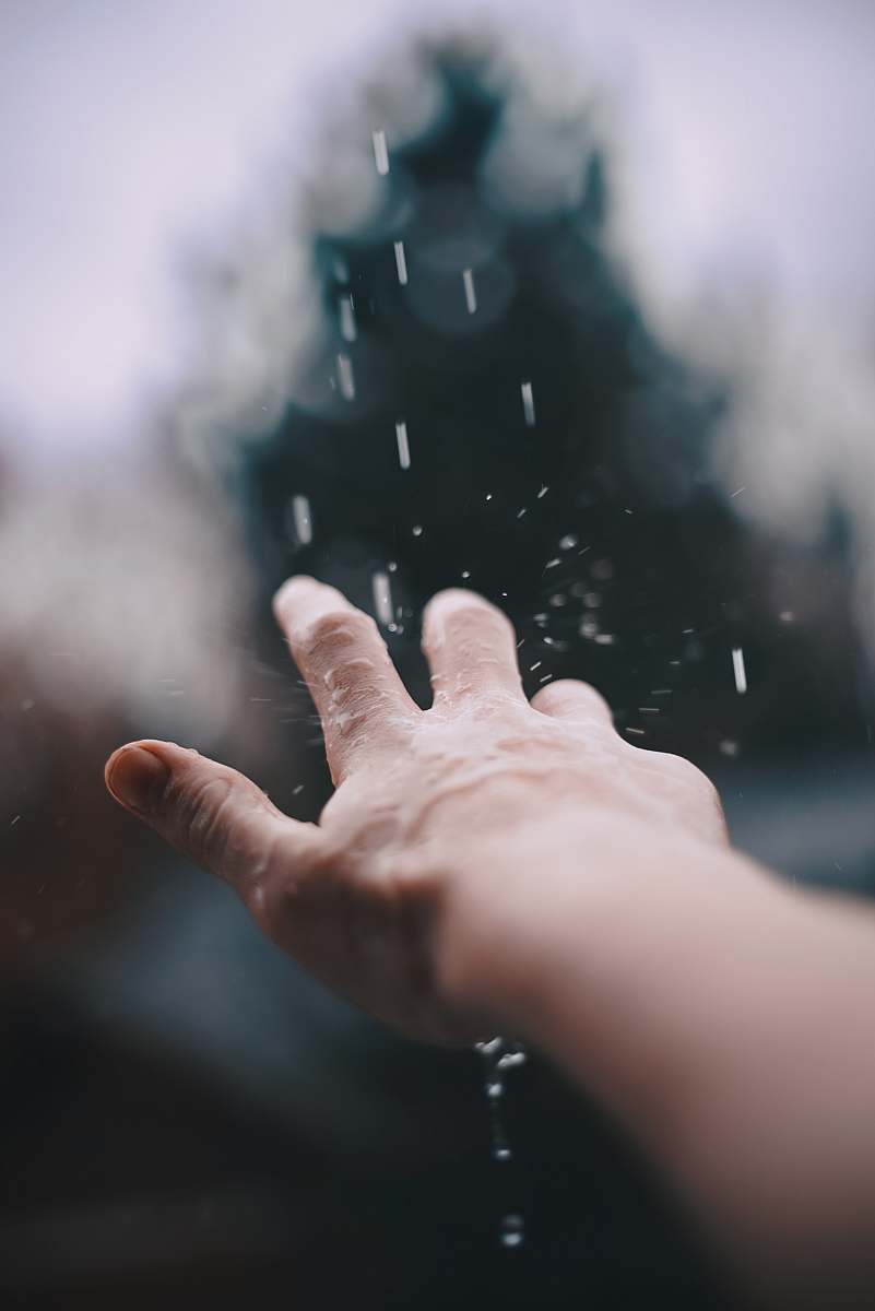 person selective focus photography of person's hand with water hand