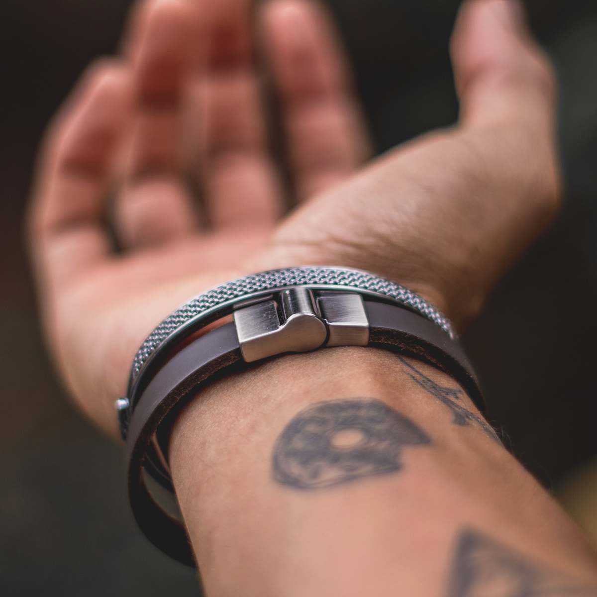 person shallow focus photography of silver-colored bracelet skin