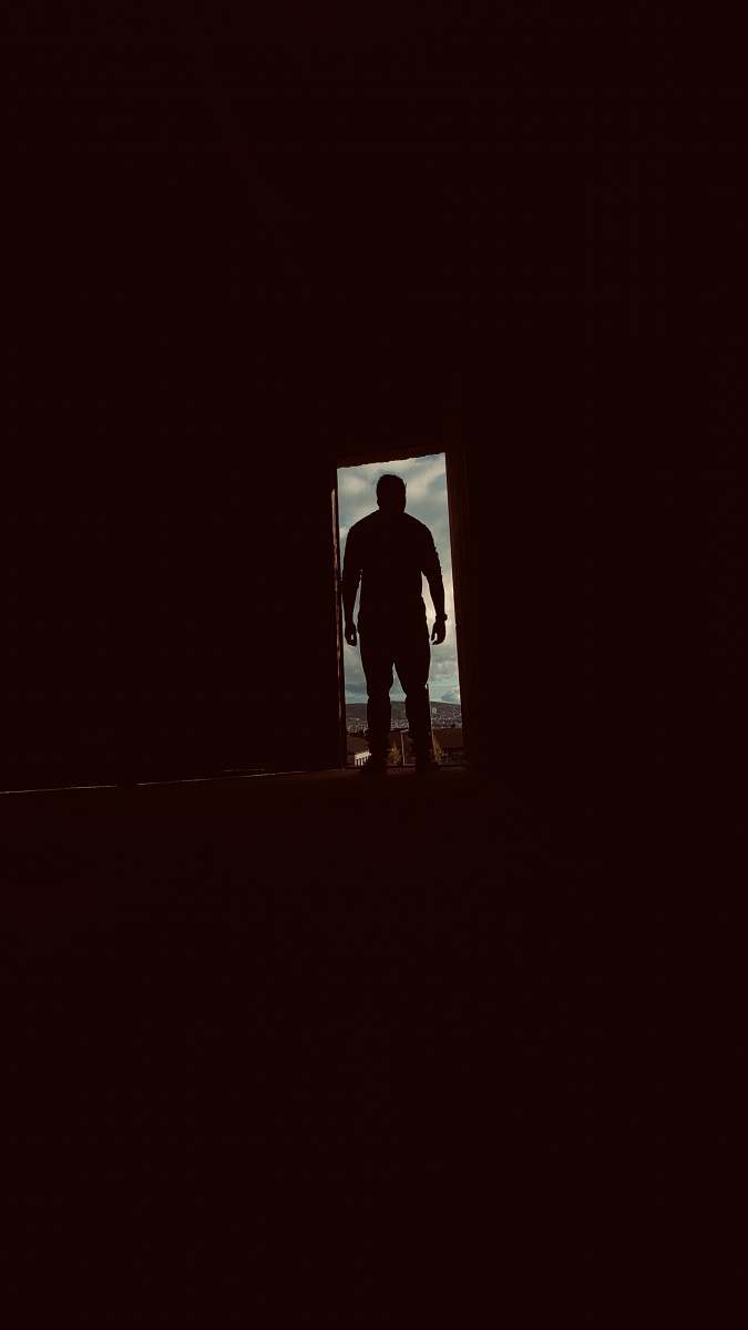 hand silhouette of man standing in door person