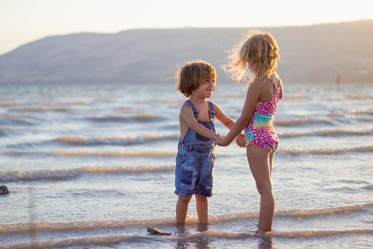person two girls standing on seashore family